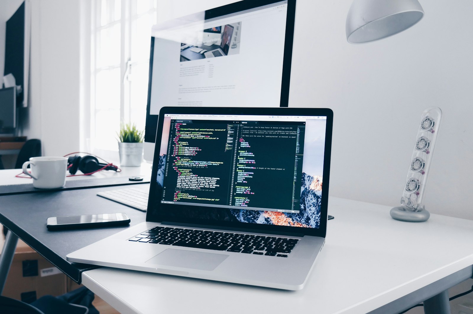 A laptop and monitor on a developer's work desk
